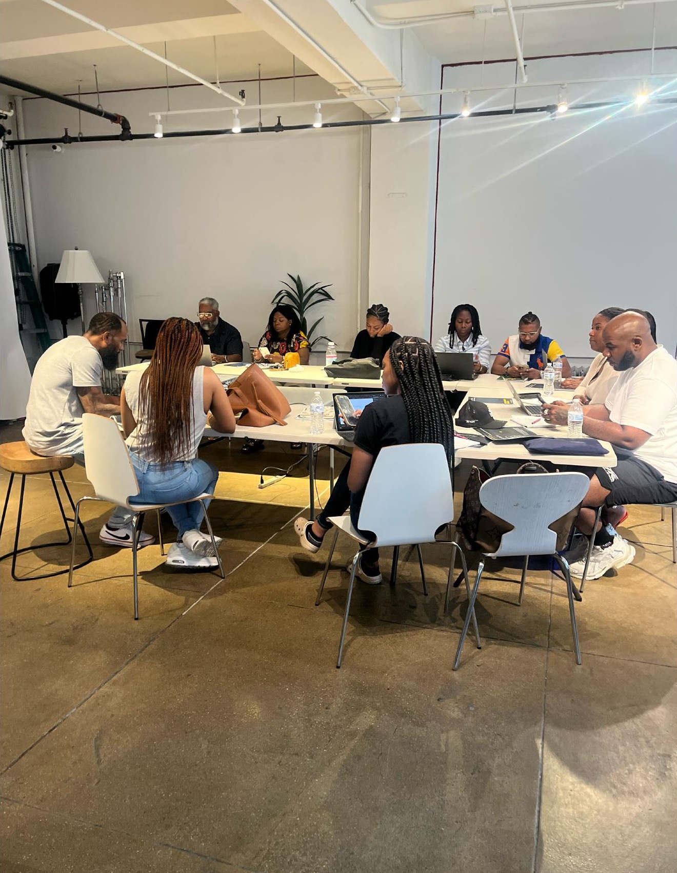 Clients working together around a table during a previous learning experience